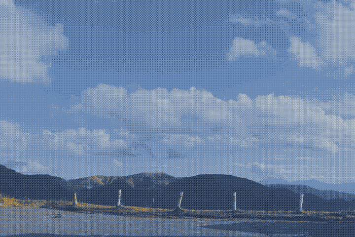 clouds in the blue sky, mountains below, posts in the ground thumbnail