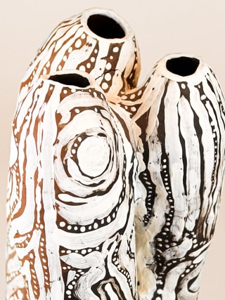photograph of earthen ceramic sculpture, hand painted with patterns, close up view, thumbnail